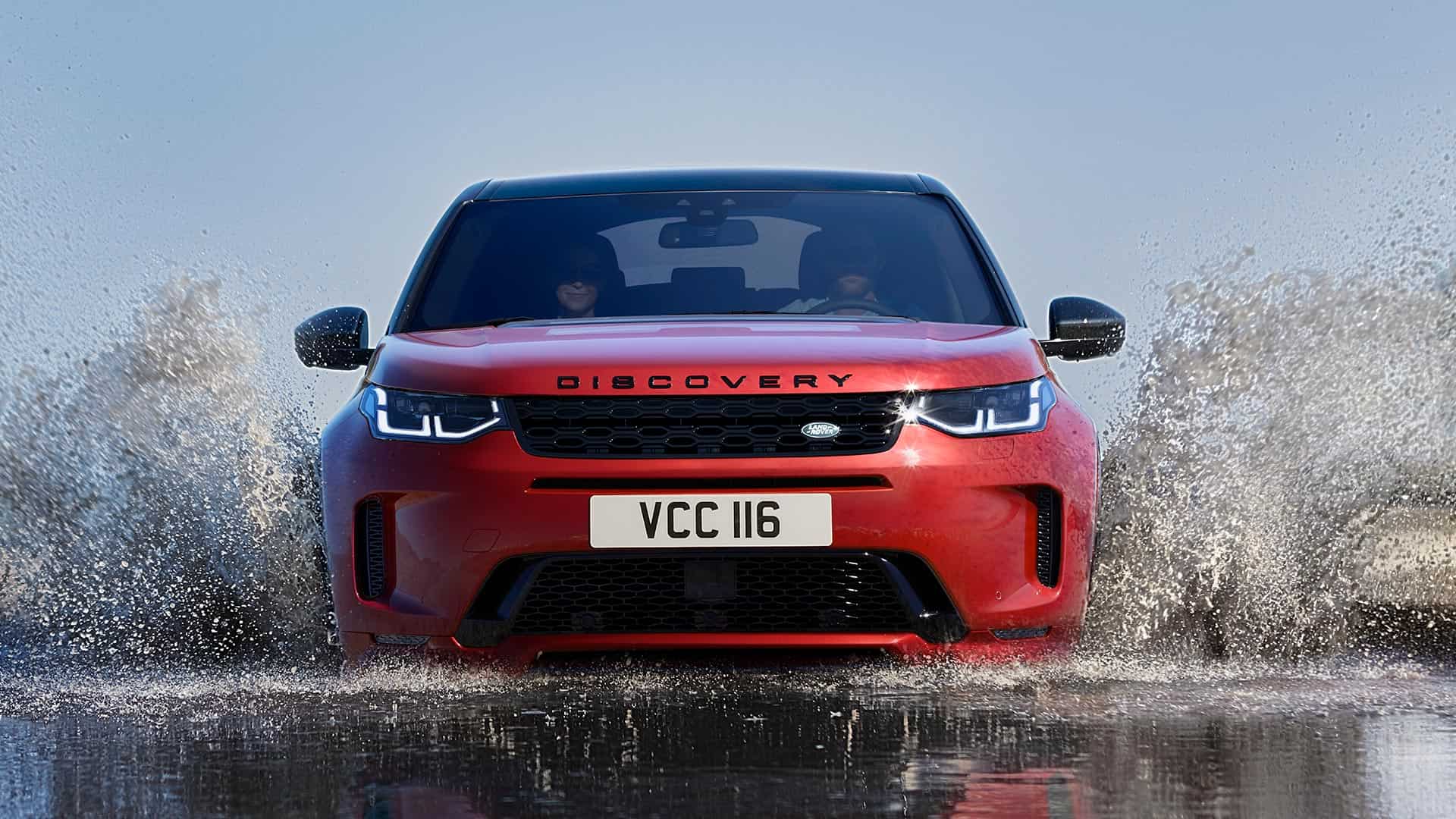 Red discovery driving through water