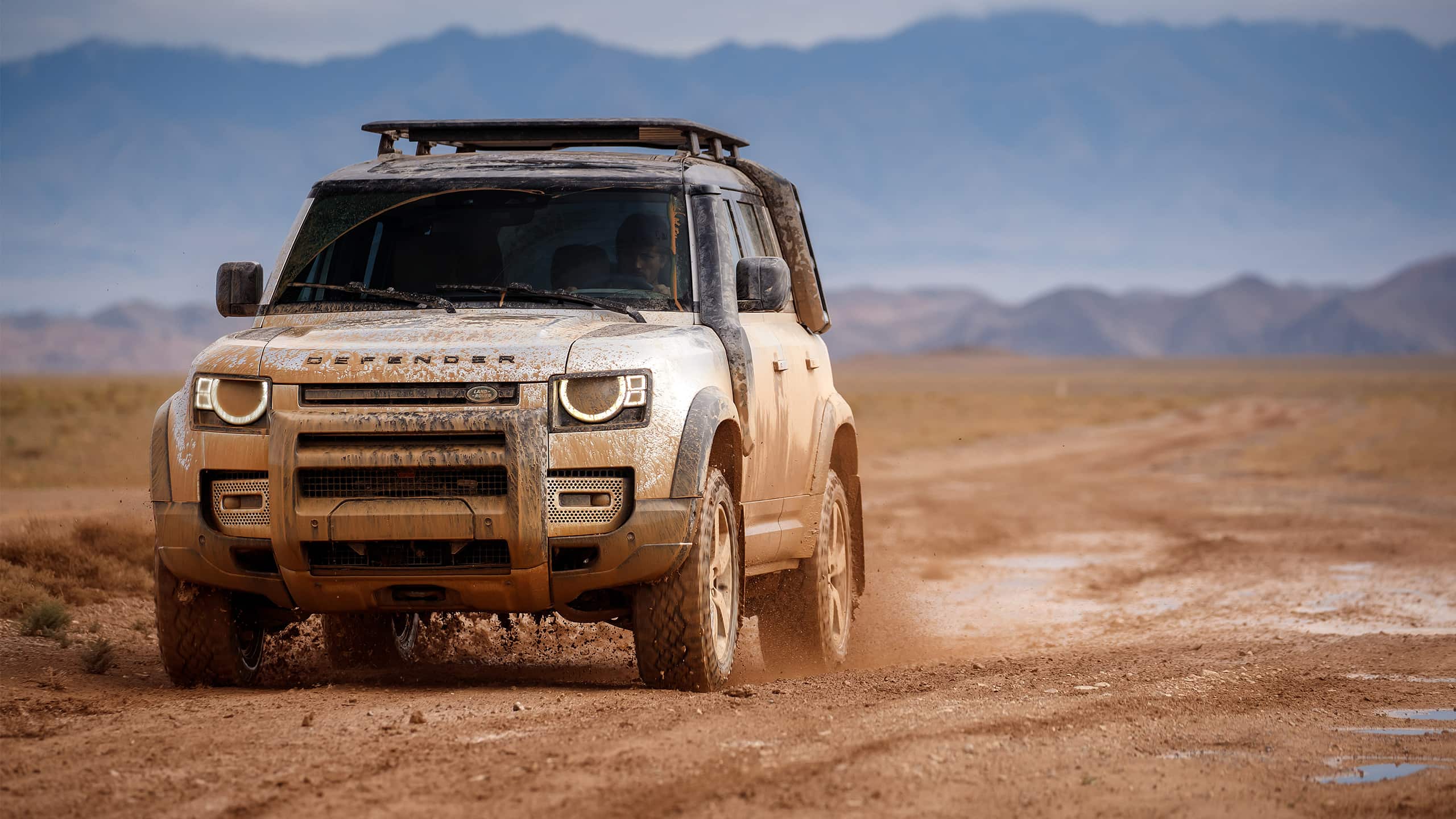 Defender driving in sand