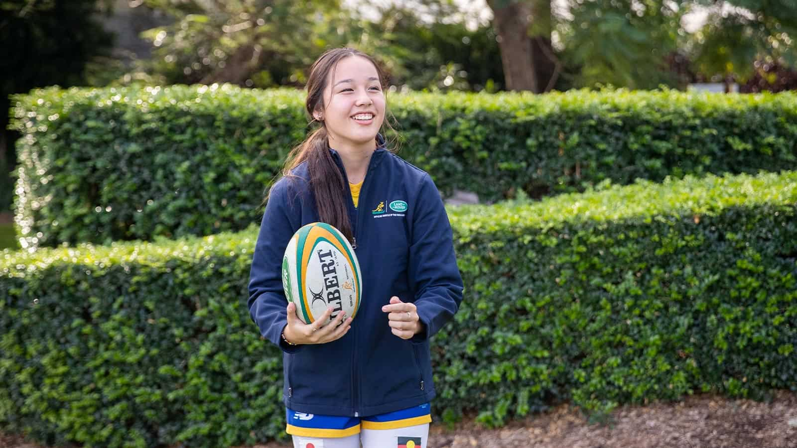 Girl holding a rugby ball